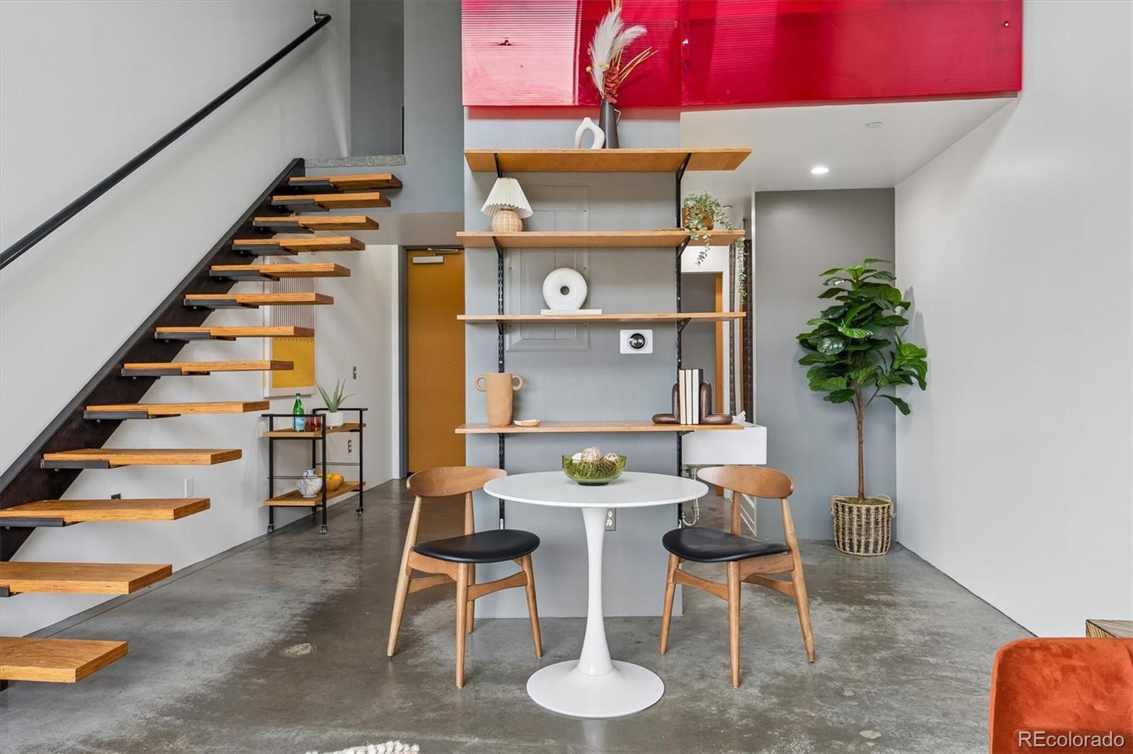 3457 Ringsby Court, Unit 347 Denver, CO 80216 - Photo 2 of 22 a view of a dining room with furniture and wooden floor