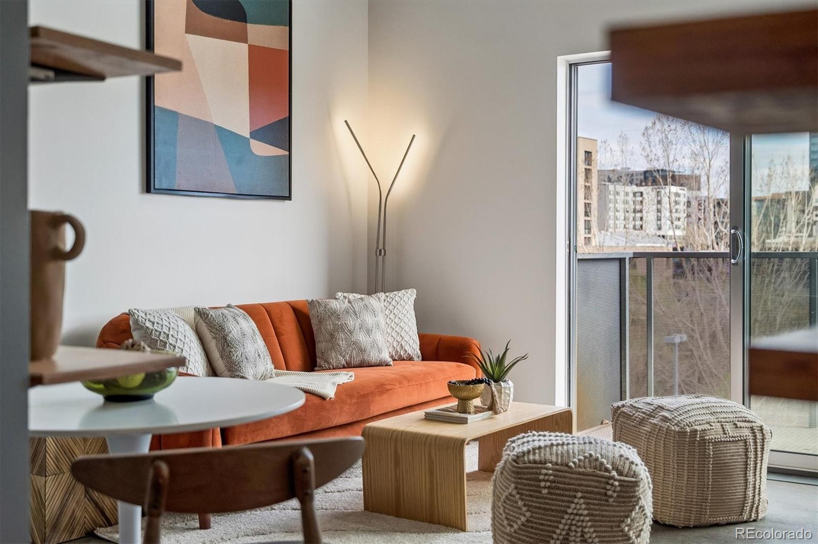 3457 Ringsby Court, Unit 347 Denver, CO 80216 - Photo 3 of 22 a living room with furniture and a window
