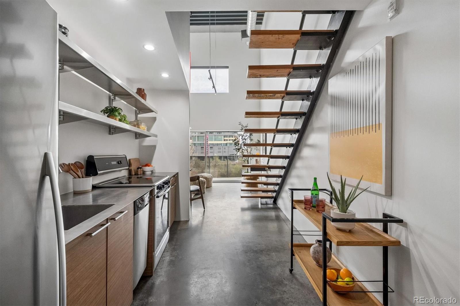 3457 Ringsby Court, Unit 347 Denver, CO 80216 - Photo 7 of 22 a kitchen with stove and cabinets