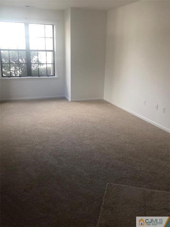 2702 Ridgefield Court, Unit 2702 Helmetta, NJ 08828 - Photo 4 of 8 an empty room with a window