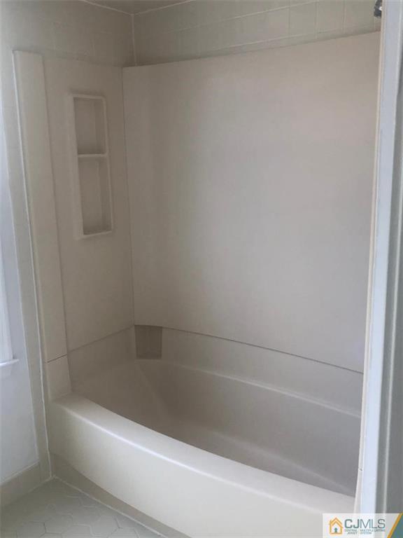 2702 Ridgefield Court, Unit 2702 Helmetta, NJ 08828 - Photo 7 of 8 a close up of a bathtub in a bathroom