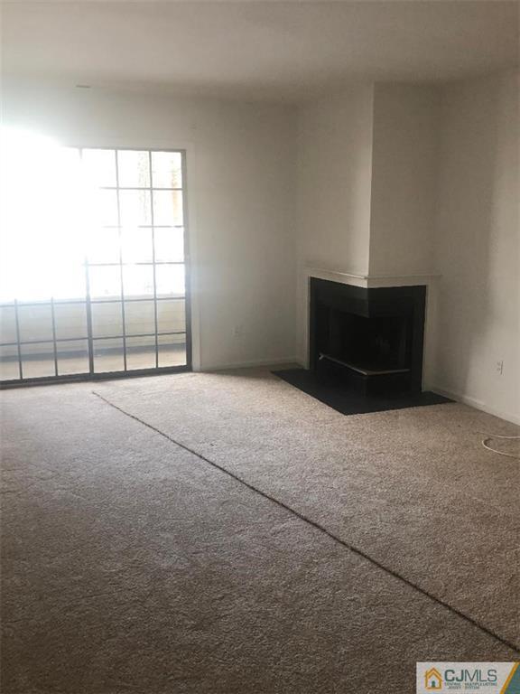 2702 Ridgefield Court, Unit 2702 Helmetta, NJ 08828 - Photo 8 of 8 a view of an empty room with a window