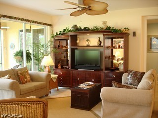 21743 Sound Way, Unit 101 Estero, FL 33928 - Photo 3 of 8 a living room with furniture and a flat screen tv