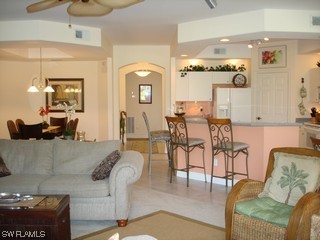 21743 Sound Way, Unit 101 Estero, FL 33928 - Photo 5 of 8 a living room with furniture and wooden floor
