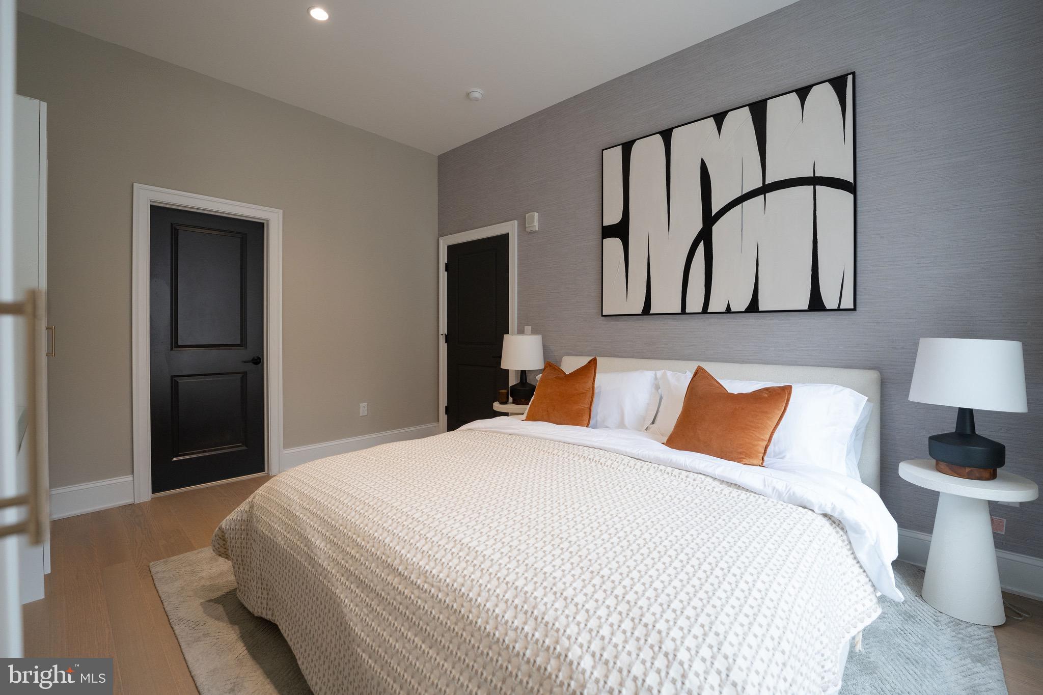 200 South Broad Street, Unit 314 Philadelphia, PA 19102 - Photo 13 of 46 a bedroom with a large bed and a painting on the wall