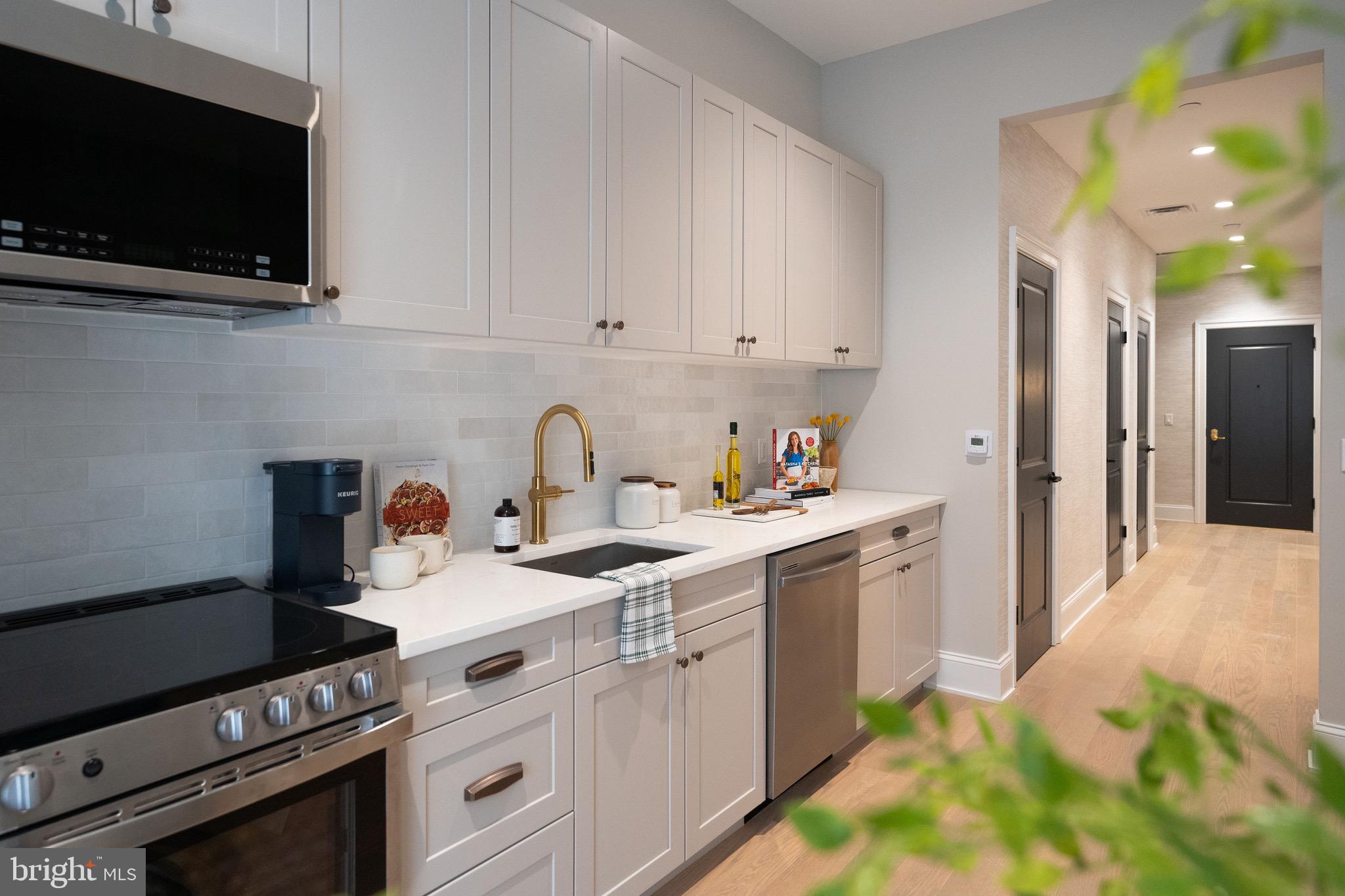 200 South Broad Street, Unit 314 Philadelphia, PA 19102 - Photo 16 of 46 a kitchen with a sink stove and microwave