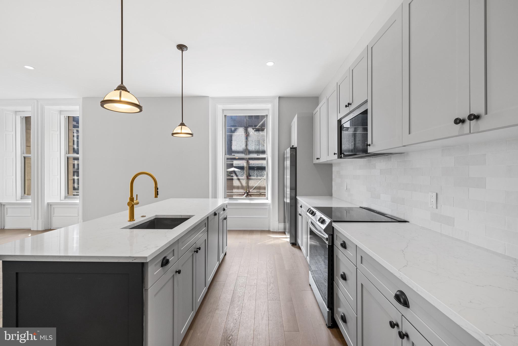 200 South Broad Street, Unit 314 Philadelphia, PA 19102 - Photo 2 of 46 a kitchen with stainless steel appliances granite countertop a sink stove and refrigerator