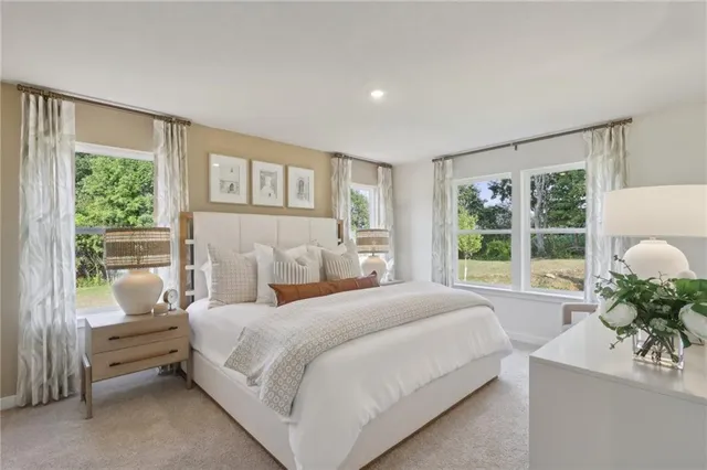 a bedroom with a bed and a couch next to a window