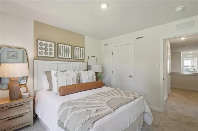 a bedroom with a bed and a lamp