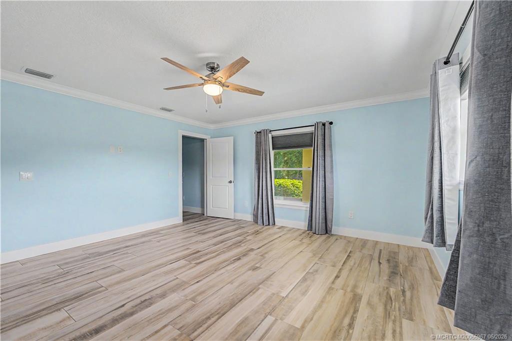 8200 Southwest Springhaven Avenue Indiantown, FL 34956 - Photo 24 of 35 a view of a room with a window and wooden floor