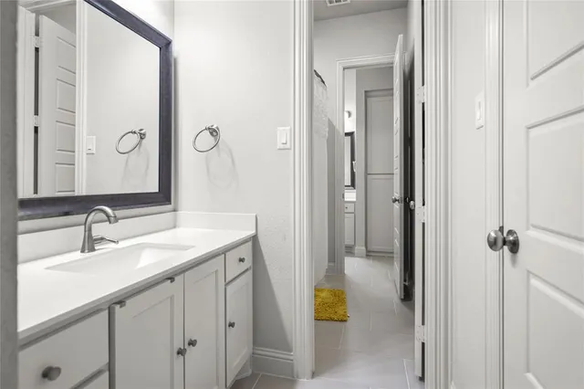 a bathroom with a sink a mirror and a shower