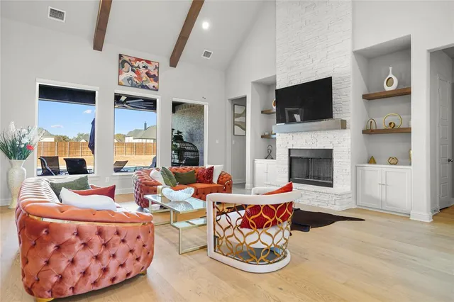 a living room with furniture flat screen tv and a fireplace