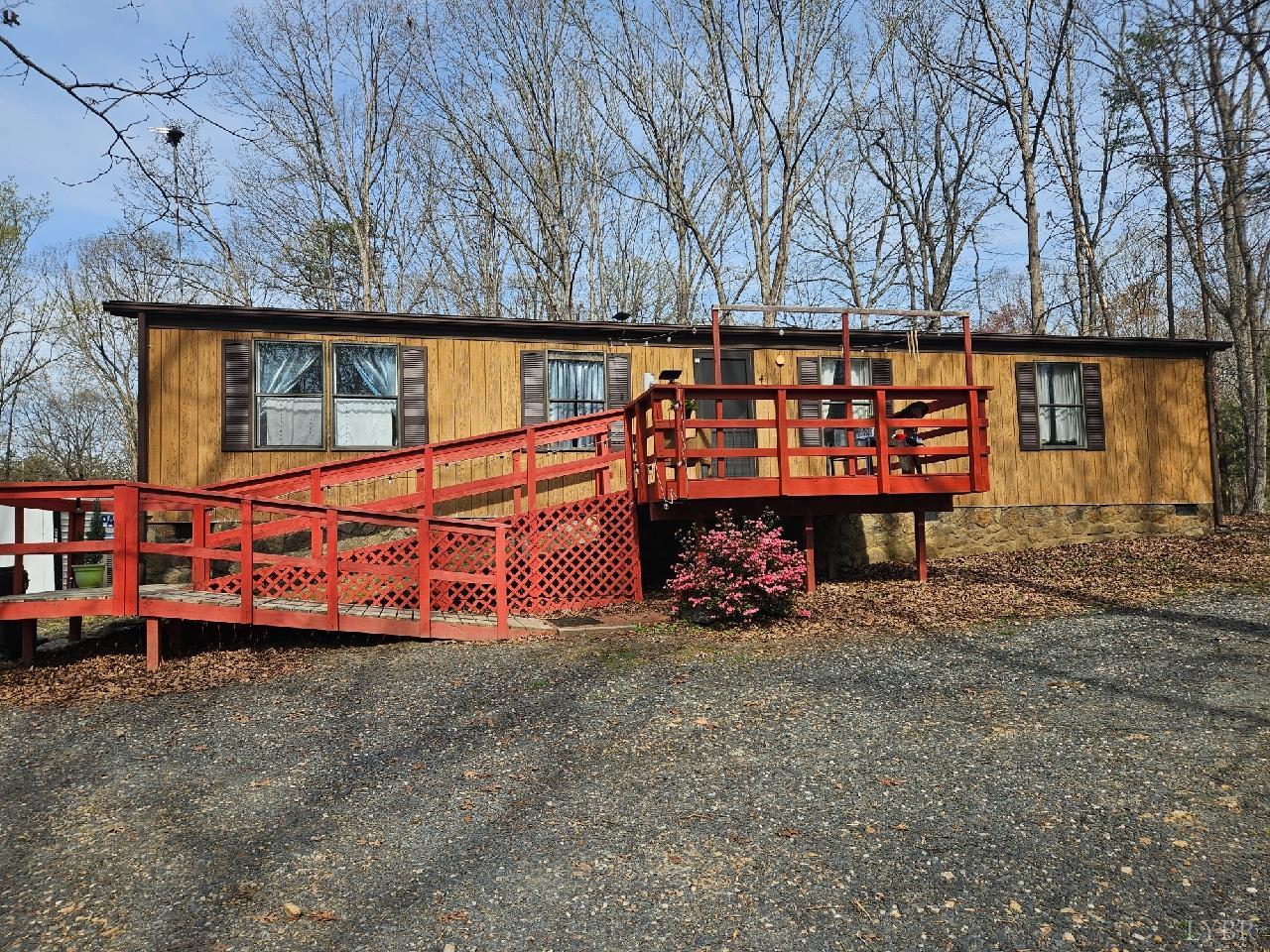 a view of a wooden house with large trees