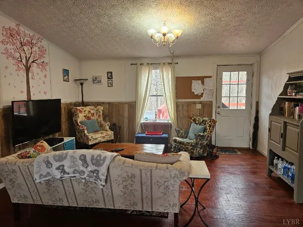 a bedroom with furniture and a flat screen tv