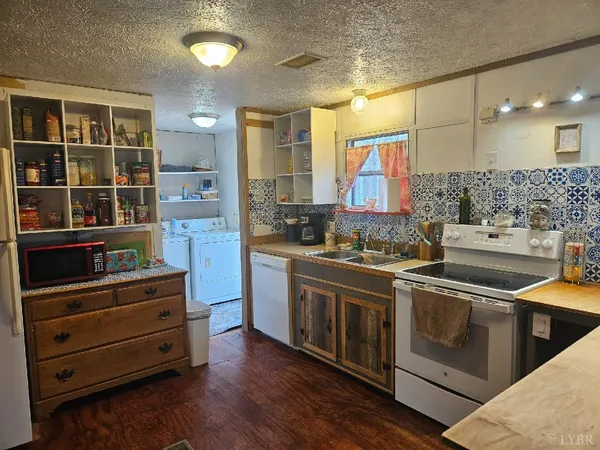 a kitchen with stainless steel appliances granite countertop a stove and a sink