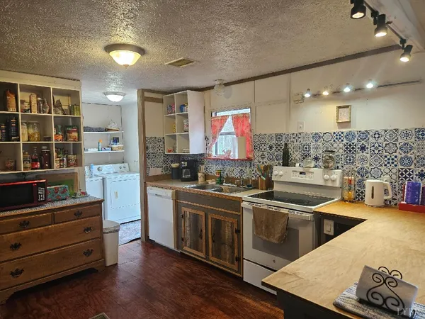 a kitchen with stainless steel appliances kitchen island granite countertop a sink and cabinets