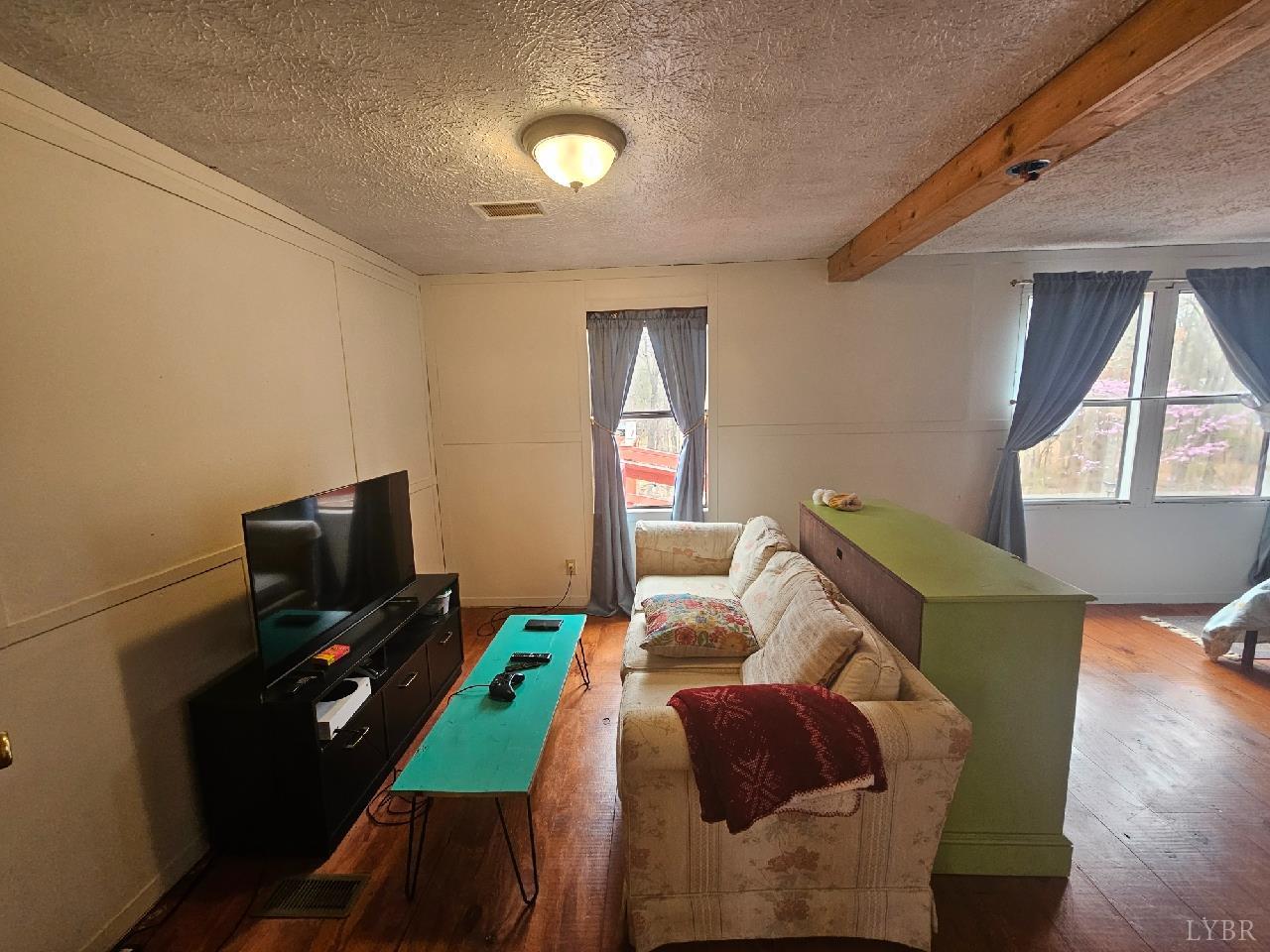 413 Plum Branch Road Lynchburg, VA 24504 - Photo 6 of 22 a living room with furniture a flat screen tv and a window