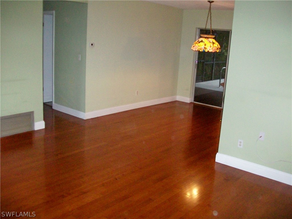 1714 Ridgecrest Street Lehigh Acres, FL 33936 - Photo 3 of 19 an empty room with a windows and chandelier