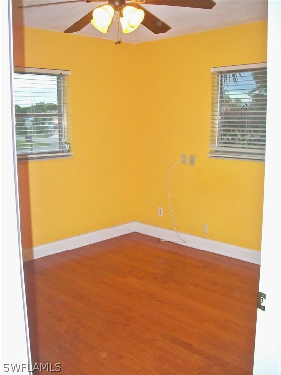 1714 Ridgecrest Street Lehigh Acres, FL 33936 - Photo 8 of 19 a view of an empty room with a window and a ceiling fan