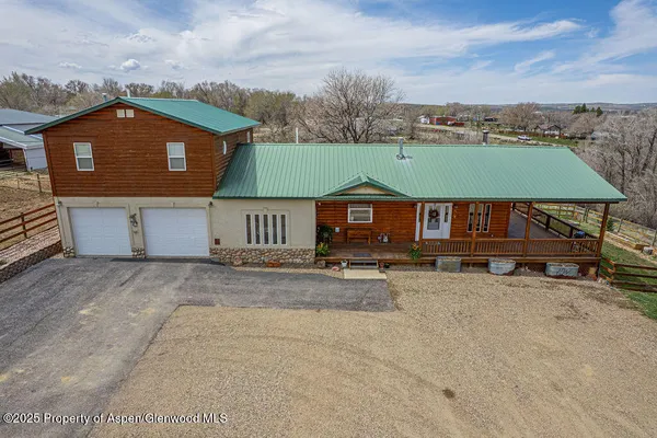 an aerial view of a house with a yard
