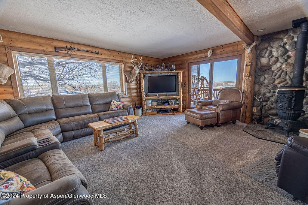 1020 Thompson Way Craig, CO 81625 - Photo 11 of 92 a living room with furniture a large window and a flat screen tv