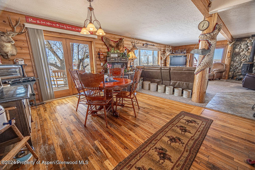 1020 Thompson Way Craig, CO 81625 - Photo 13 of 92 a dining room with furniture a chandelier and wooden floor