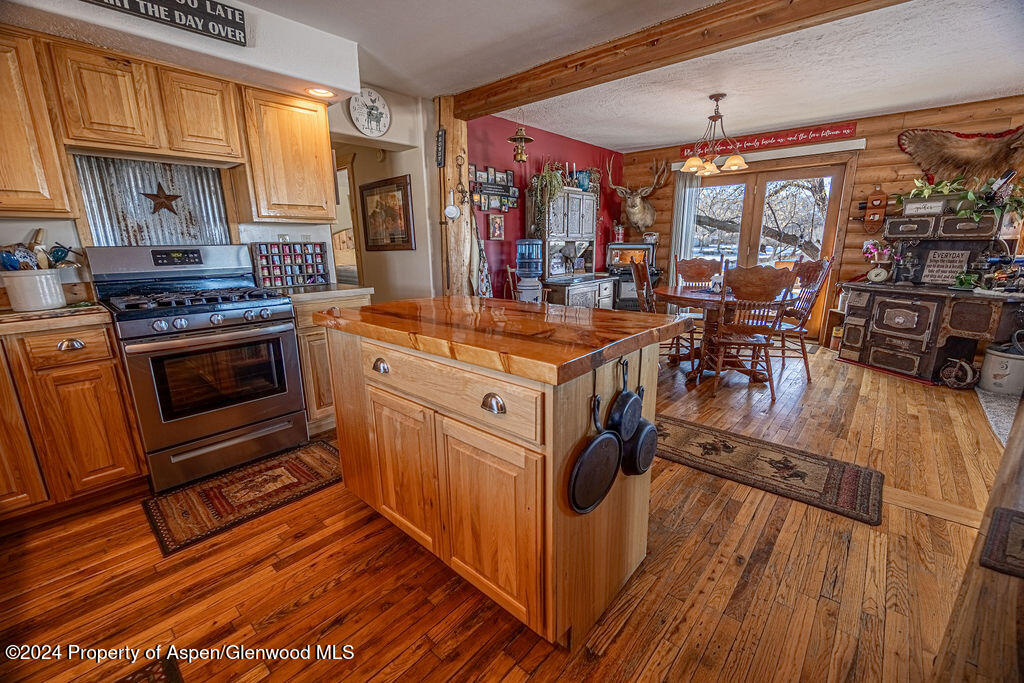 1020 Thompson Way Craig, CO 81625 - Photo 17 of 92 a kitchen with stainless steel appliances granite countertop a stove and a wooden floors