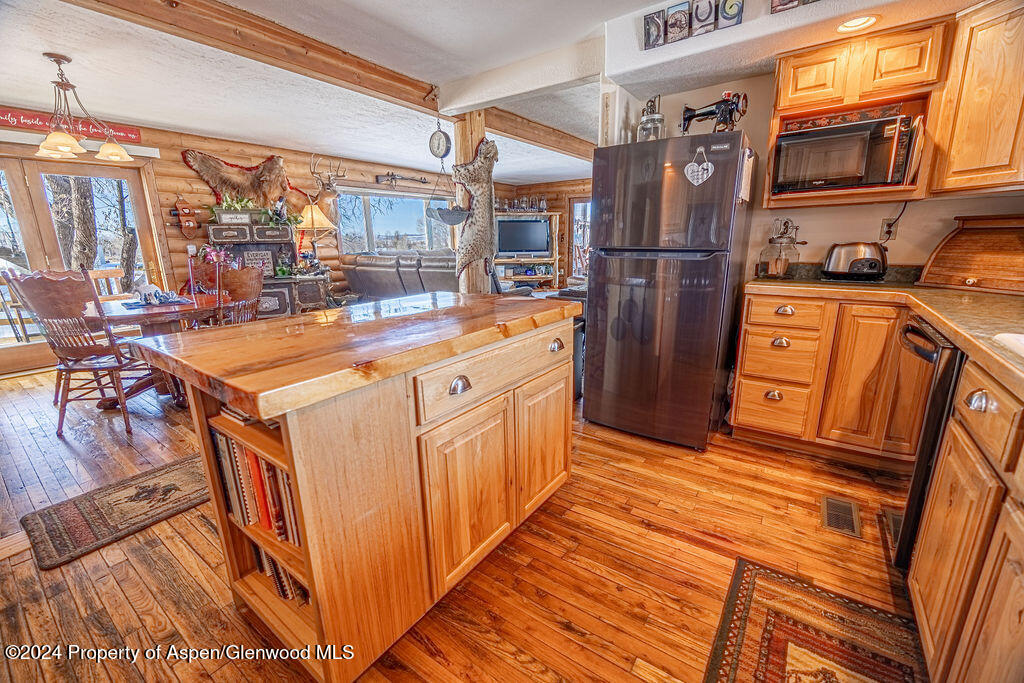 1020 Thompson Way Craig, CO 81625 - Photo 18 of 92 a kitchen with stainless steel appliances granite countertop a refrigerator a stove and a sink with large cabinets