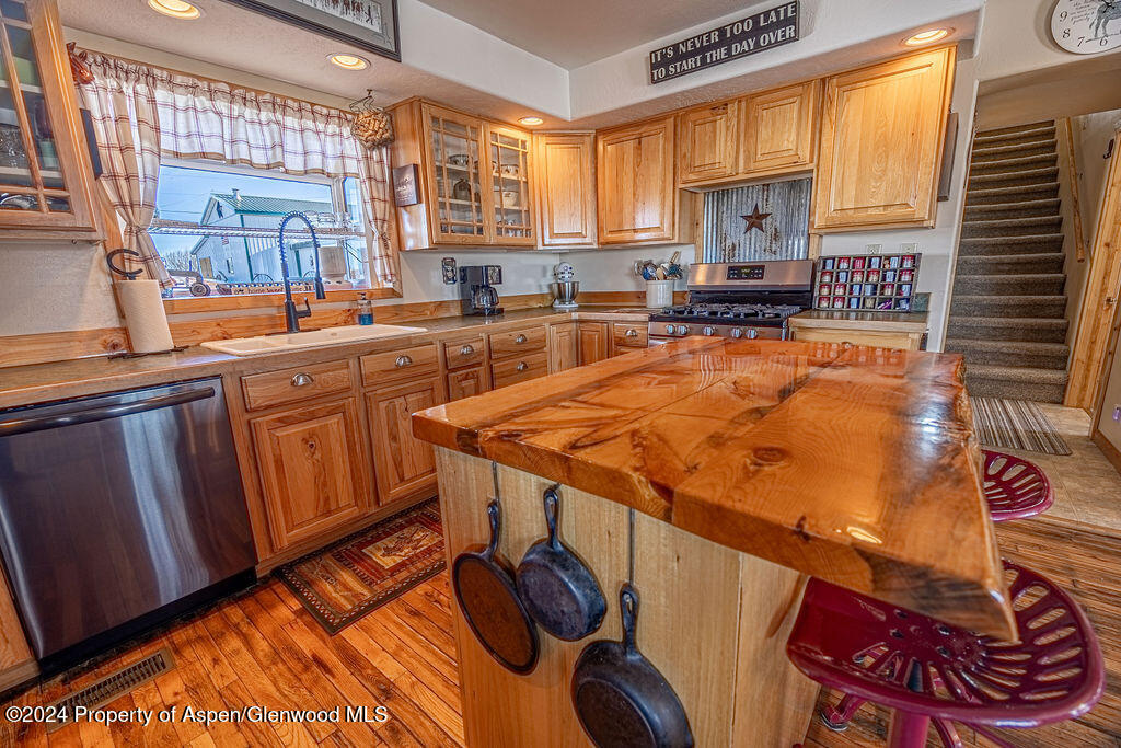 1020 Thompson Way Craig, CO 81625 - Photo 19 of 92 a kitchen with stainless steel appliances granite countertop sink stove and cabinets