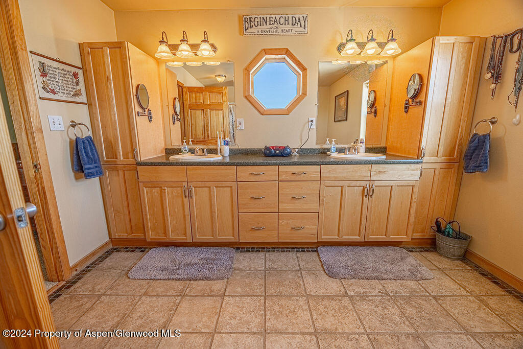 1020 Thompson Way Craig, CO 81625 - Photo 26 of 92 a spacious bathroom with a mirror a sink and a mirror