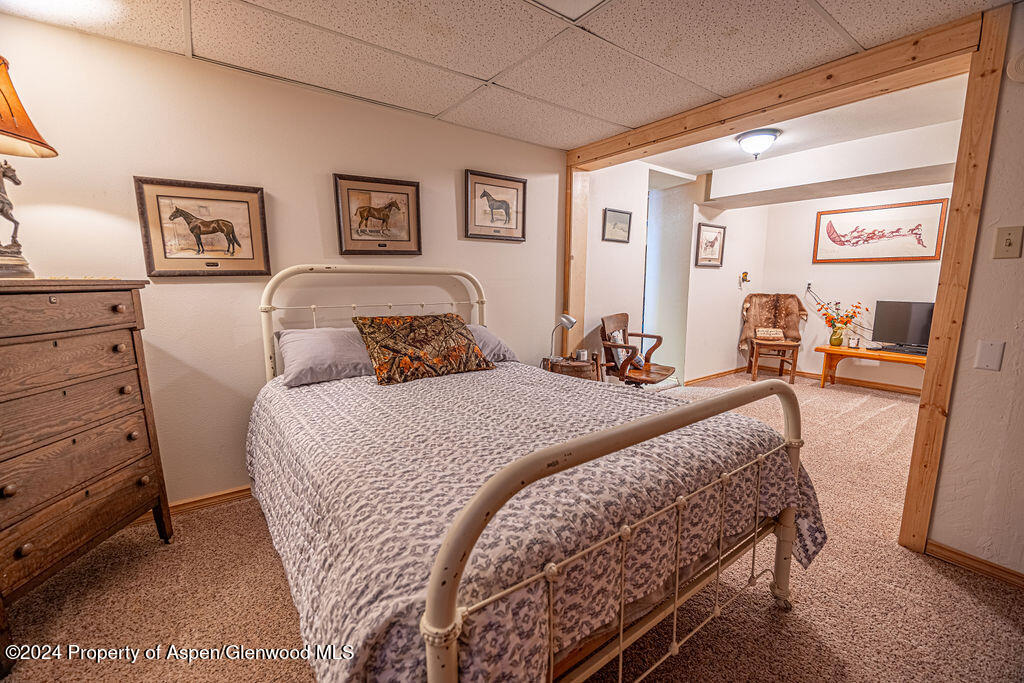 1020 Thompson Way Craig, CO 81625 - Photo 36 of 92 a bedroom with a bed and wooden floor