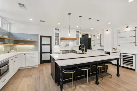 a kitchen with granite countertop and chairs
