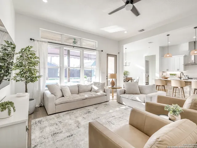 a living room with furniture and a large window