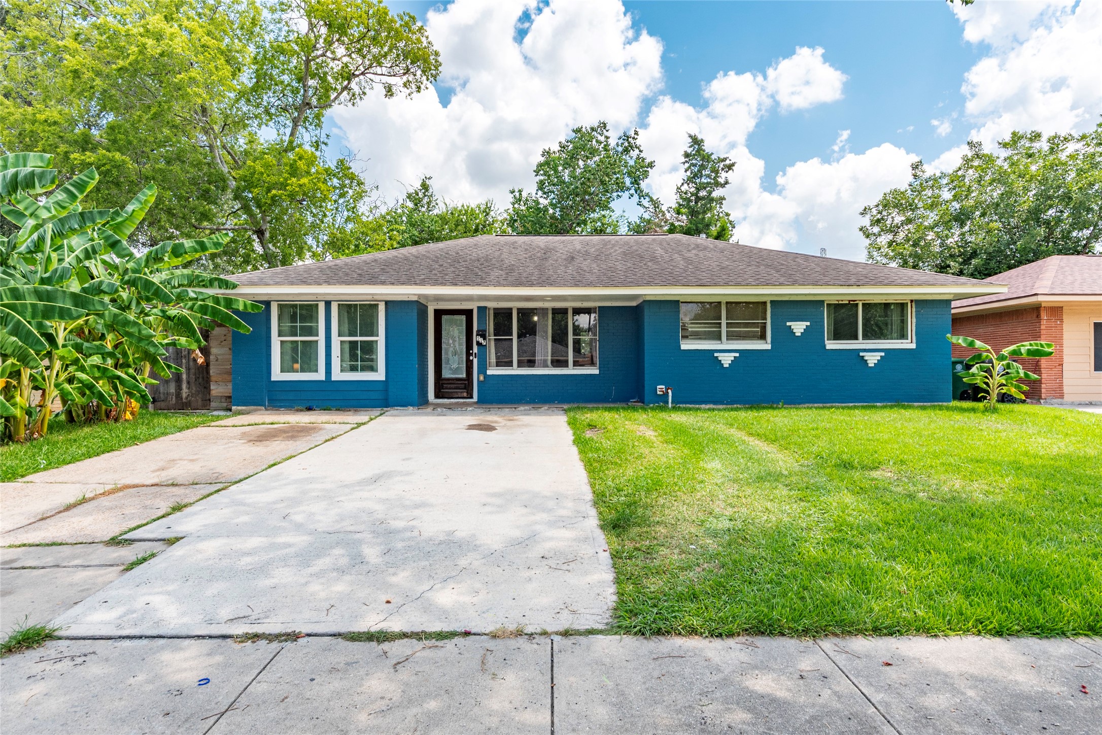 a front view of a house with a garden