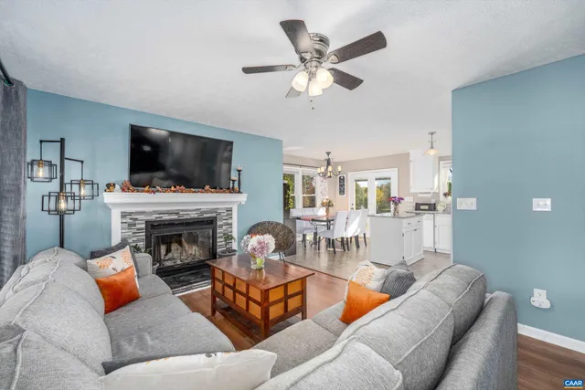a living room with furniture a flat screen tv and a fireplace