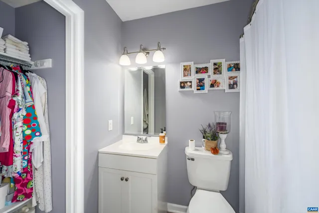 a bathroom with a sink mirror and vanity
