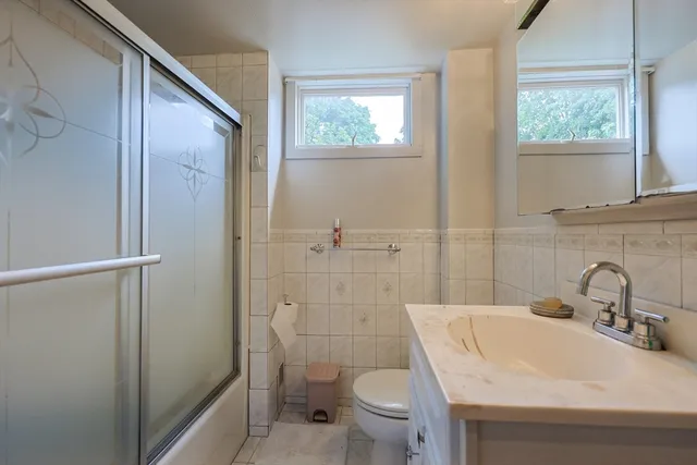 a bathroom with a sink toilet and shower