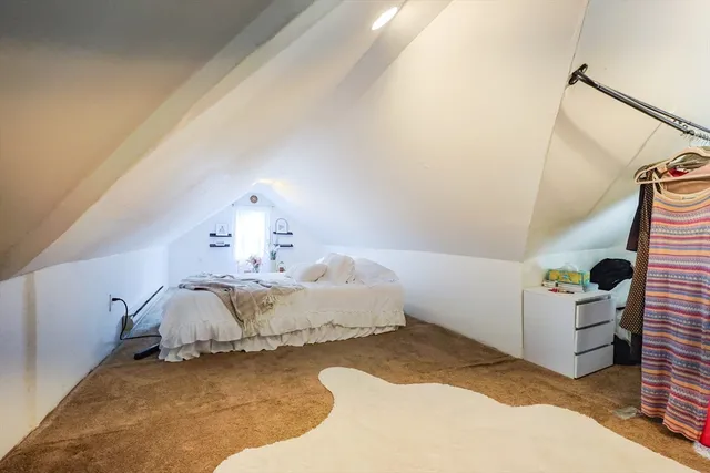 a spacious bedroom with a bed and a window