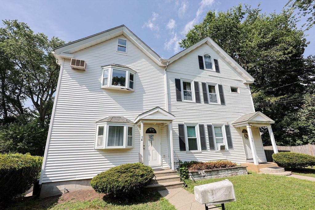 7 Jackson Court, Unit B Natick, MA 01760 - Photo 2 of 28 a front view of a house with a yard