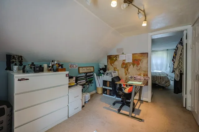 a bed room with a bed and a chair