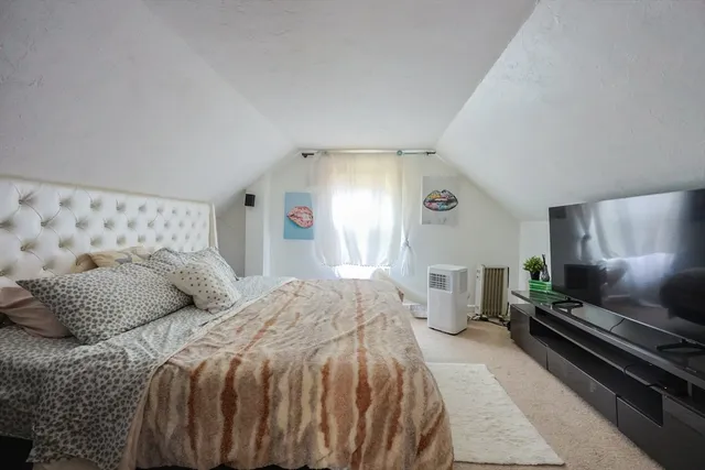 a bedroom with a bed and window