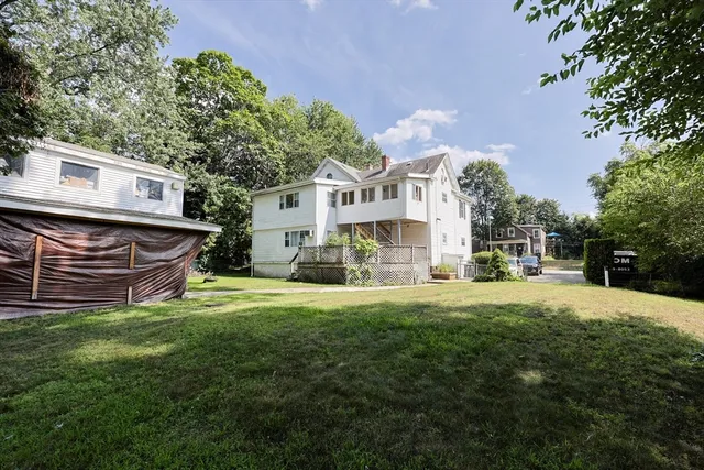 a view of a house with a yard and sitting area