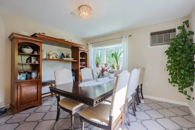 a dining room with furniture and window