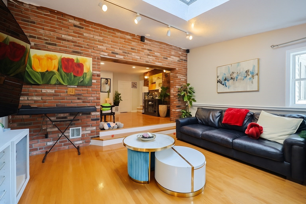 7 Jackson Court, Unit B Natick, MA 01760 - Photo 10 of 28 a living room with furniture and a flat screen tv