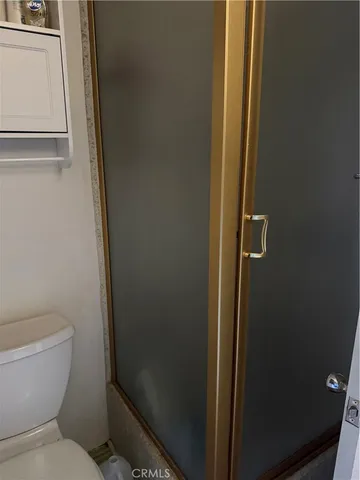 a bathroom with a toilet and a shower