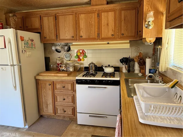 a kitchen with a refrigerator and white cabinets
