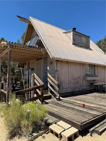 a view of a house with a wooden deck