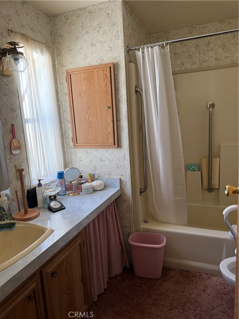97940 Deodar Road Kennedy Meadows, CA 93527 - Photo 8 of 21 a bathroom with a sink a toilet a mirror and shower