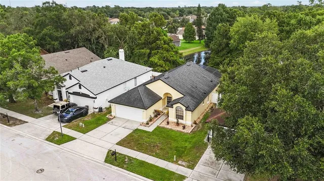 an aerial view of a house with yard swimming pool and mountain view