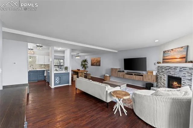 a living room with fireplace furniture and a flat screen tv